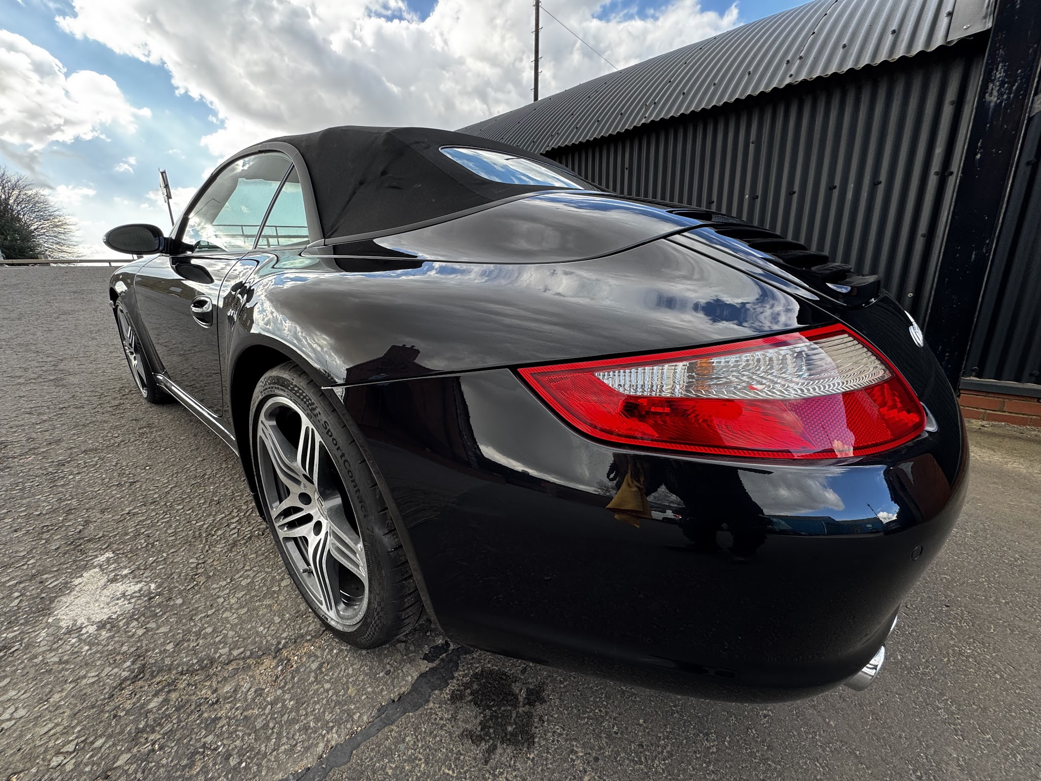 Black Porsche convertible with freshly finished paintwork